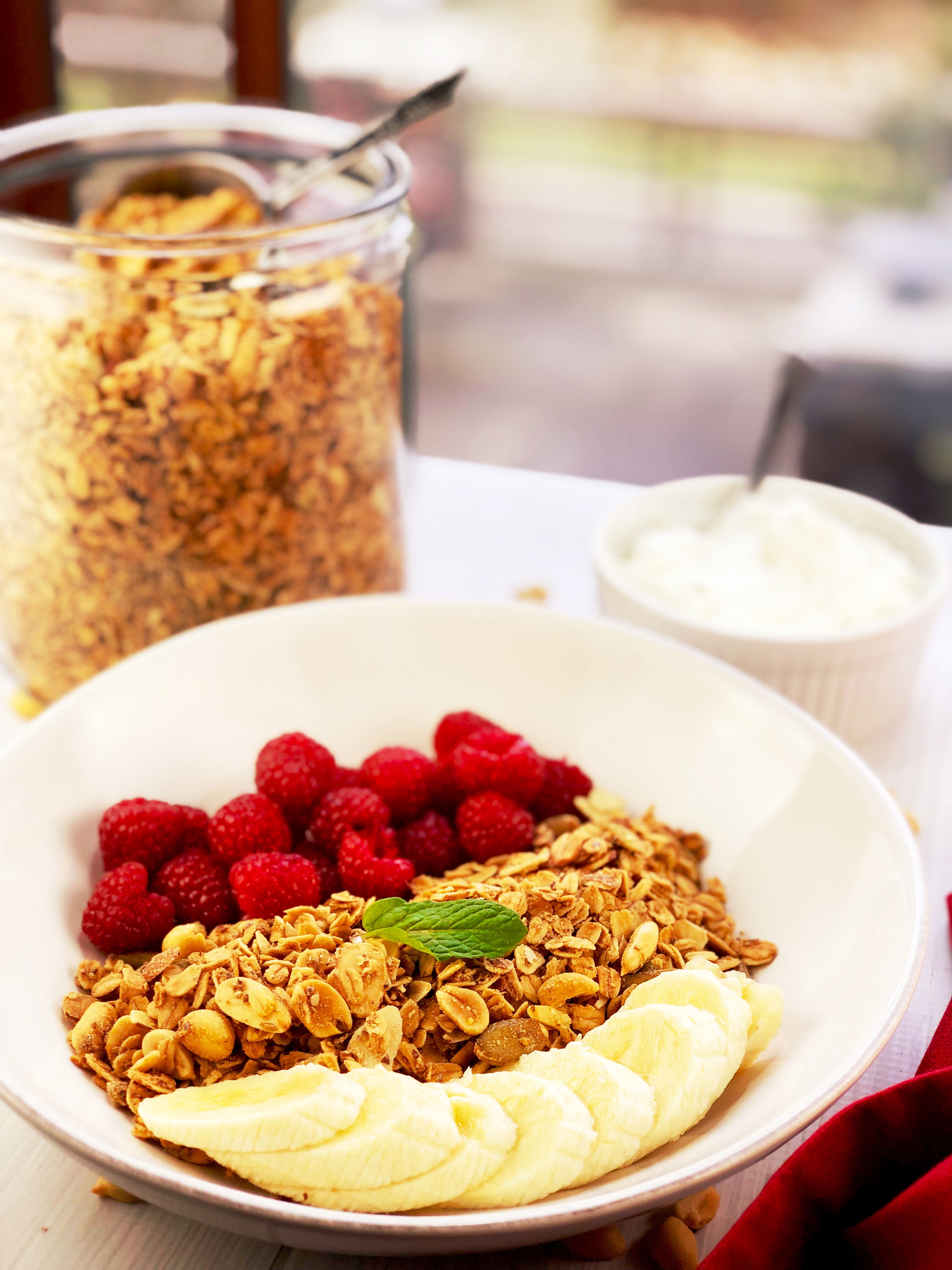 Peanut Butter Granola with raspberries and bananas