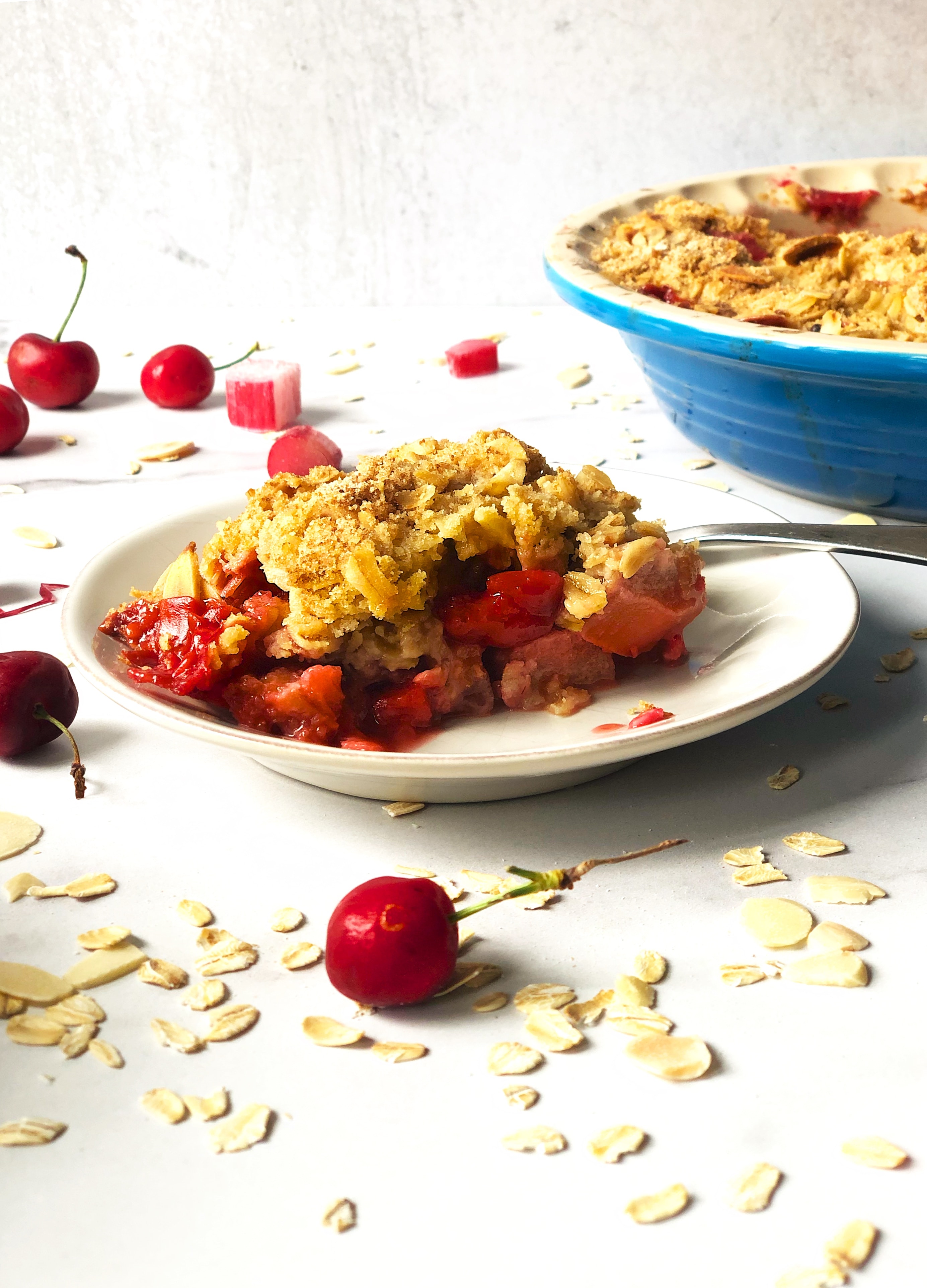 Slice of Summer Fruit Crisp - Strawberries, Rhubarb, Cherries in a buttery crisp with oats and almonds