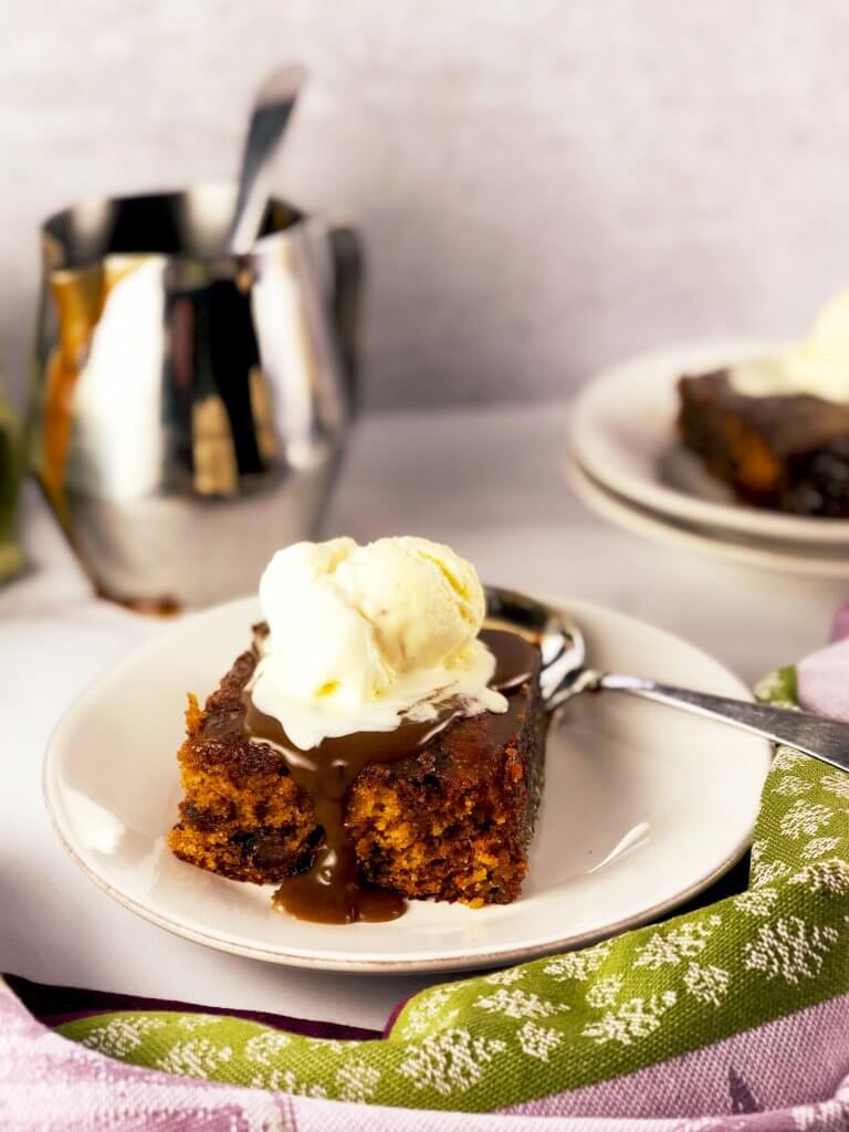 Sticky Toffee Pudding Cake with cup of toffee sauce