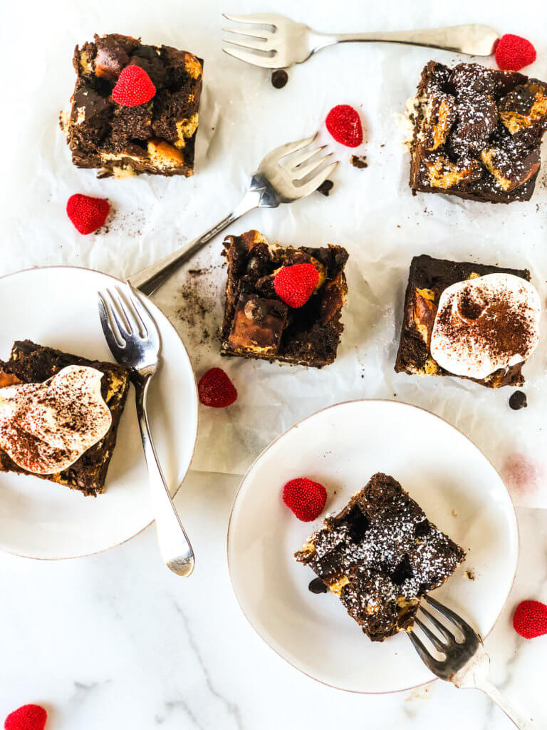 Six cliches chocolate bread pudding topped with whipped cream, or powdered sugar, or red hearts