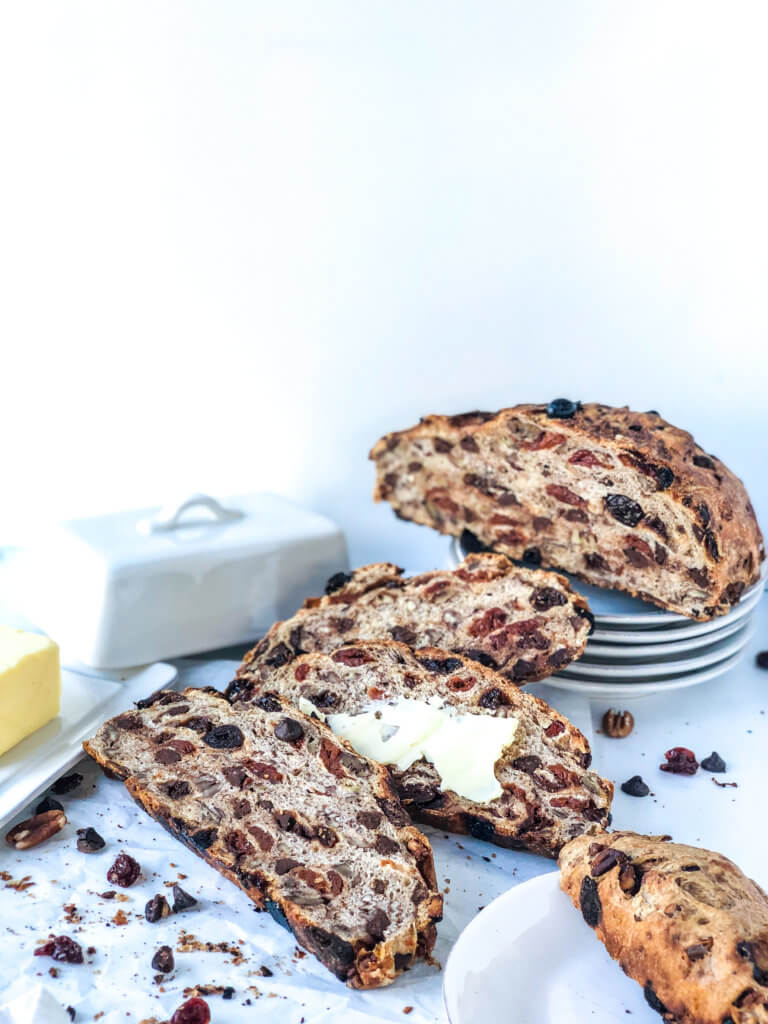 No knead bread with slices of bread, butter, and scattered dried cherries and chocolate