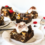 Chocolate Bread Pudding with whipped cream, several slices in background