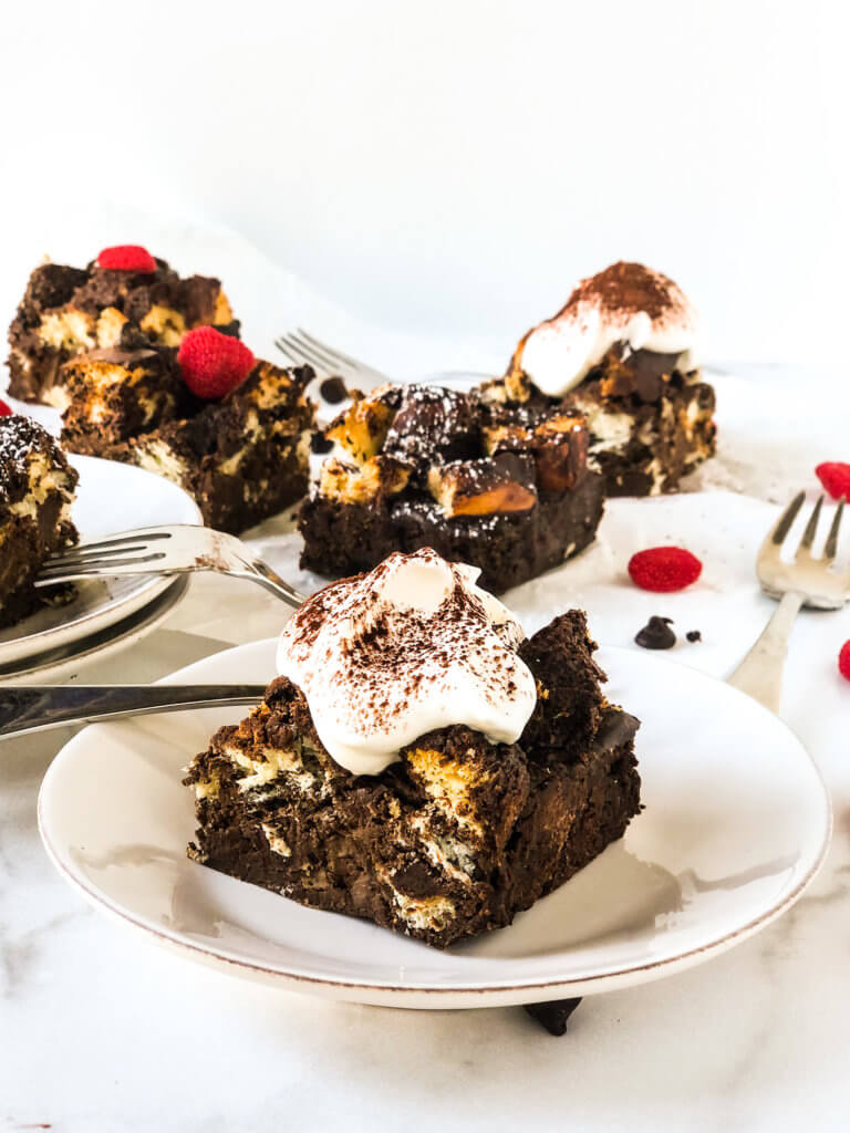 Chocolate Bread Pudding with whipped cream, several slices in background