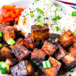 Bowl of crispy tofu and rice with furikake and scallions