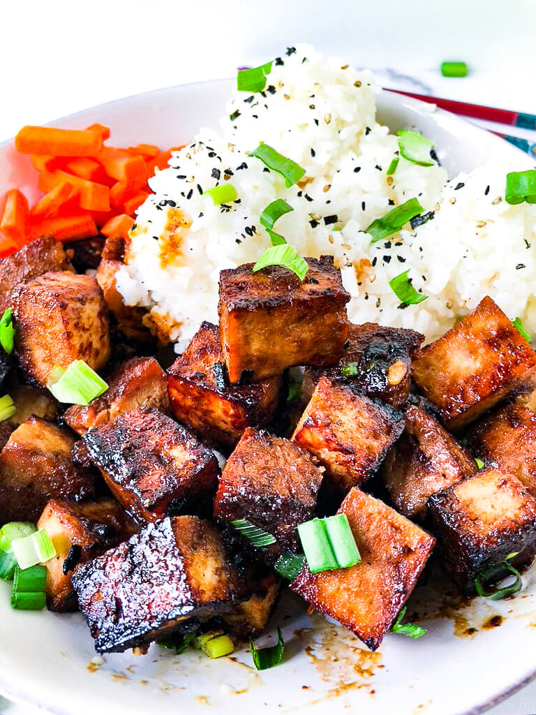 Bowl of crispy tofu and rice with furikake and scallions