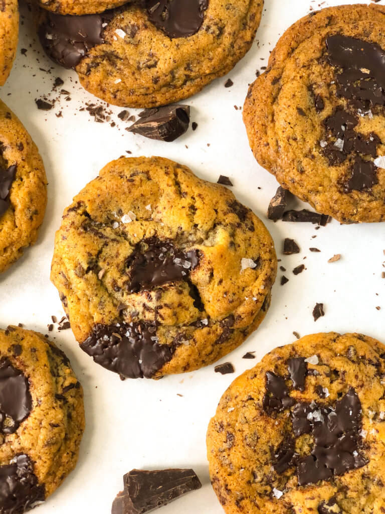 closeup of chocolate chip tahini cookie with flaky sea salt