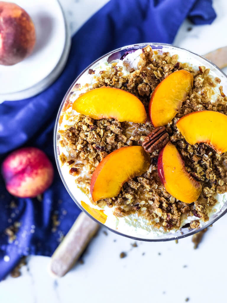 Top of Peach Crisp trifle garnished with fresh peach slices