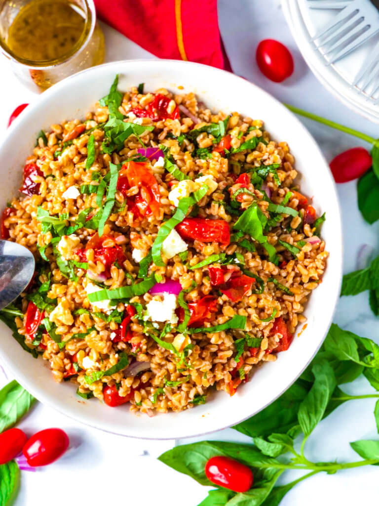 Farro Salad with roasted tomatoes, red onions and a pile of shredded mint and basil all topped with crumbled feta cheese