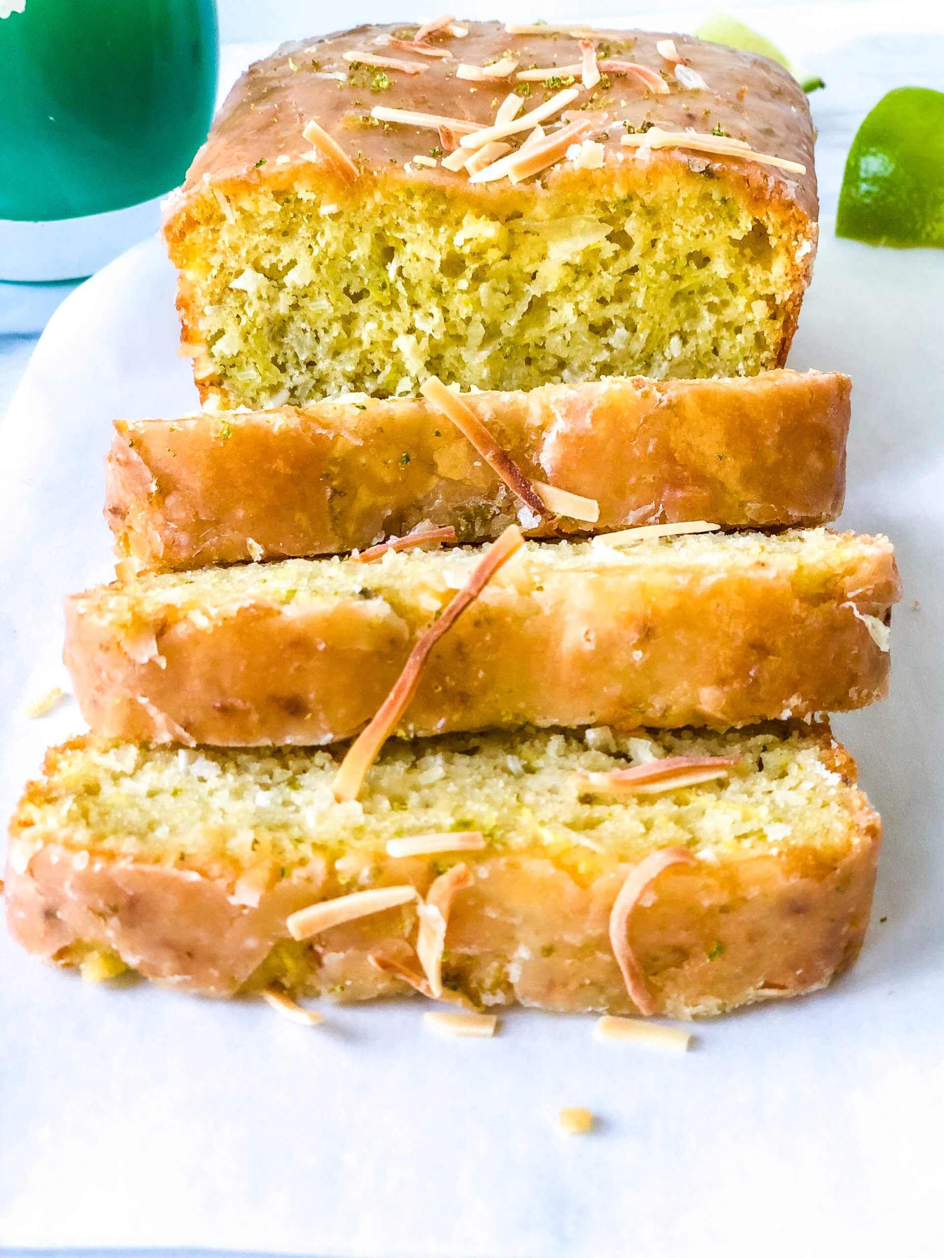 Head-on closeup of sliced Coconut Lime zucchini bread showing shiny glaze