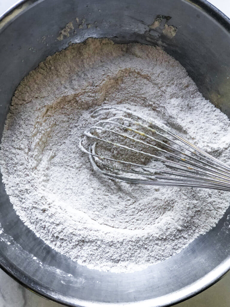 Process shot shows whisked AP Flour, baking powder and kosher salt in a metal bowl