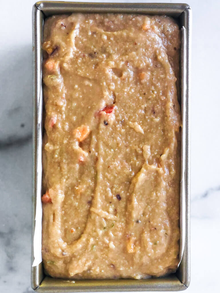 Process shot Shows loaf pan filled with batter for Peach Lime Pound Cake