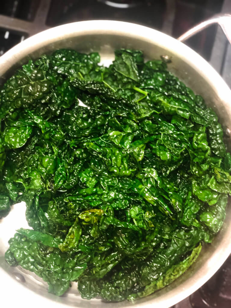 Process shot shows how the volume of the kale shrinks as it cooks