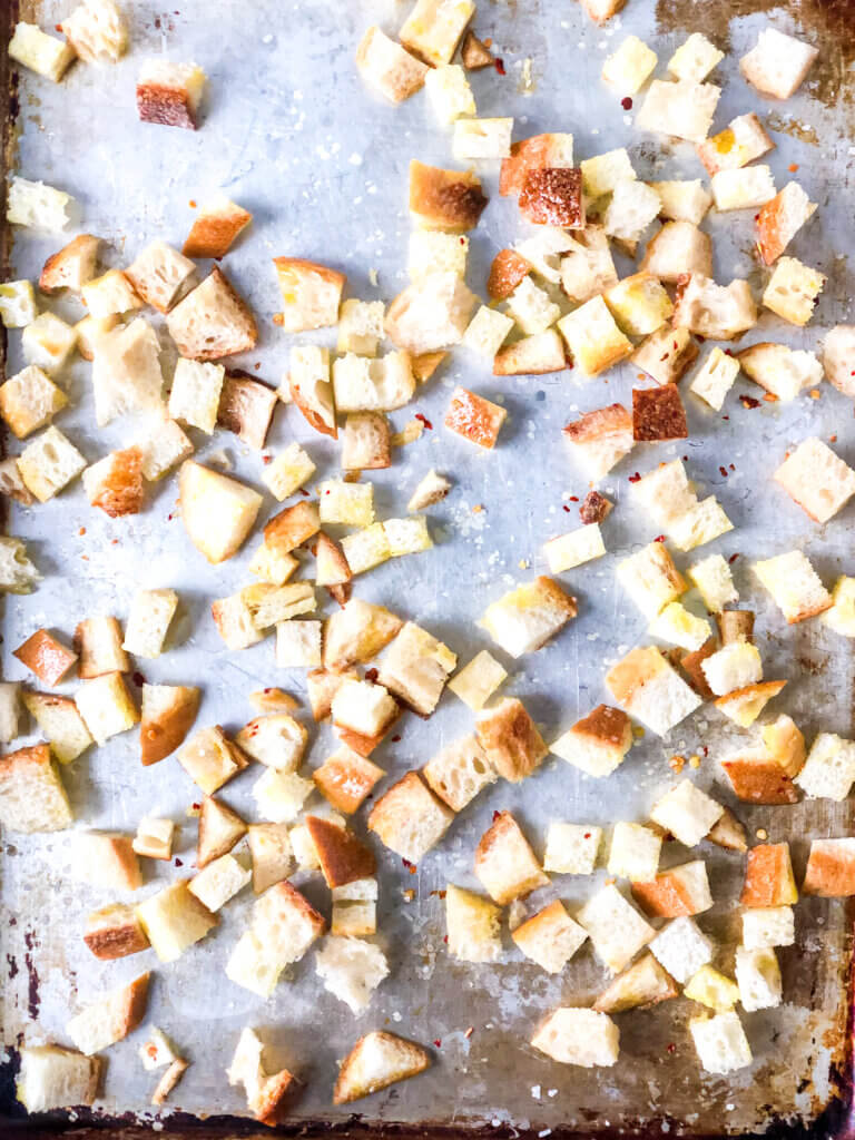 Process shot Shows 3/4-inch bread cubes spread over baking sheet