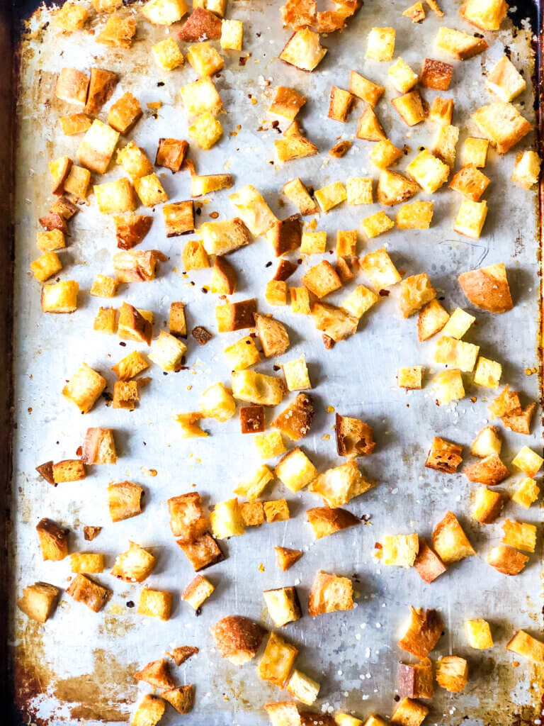 Process shot Shows toasted croutons on baking sheet