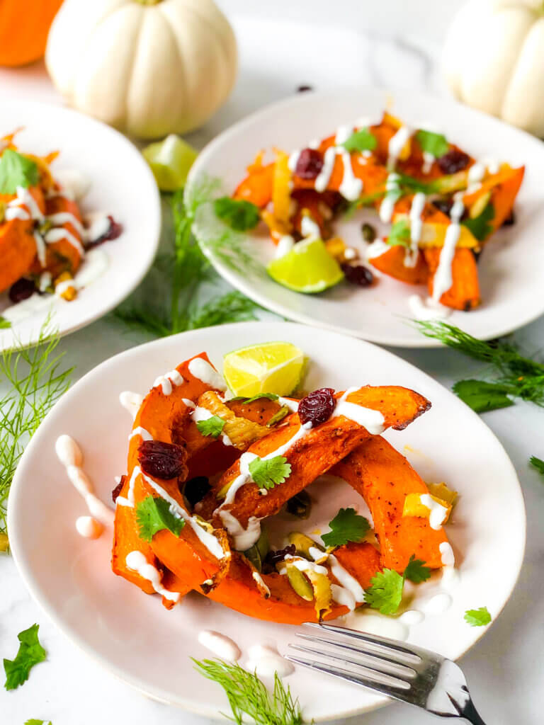 Featured photo Shows closeup of Red Kuri Squash Salad with 2 salads in background