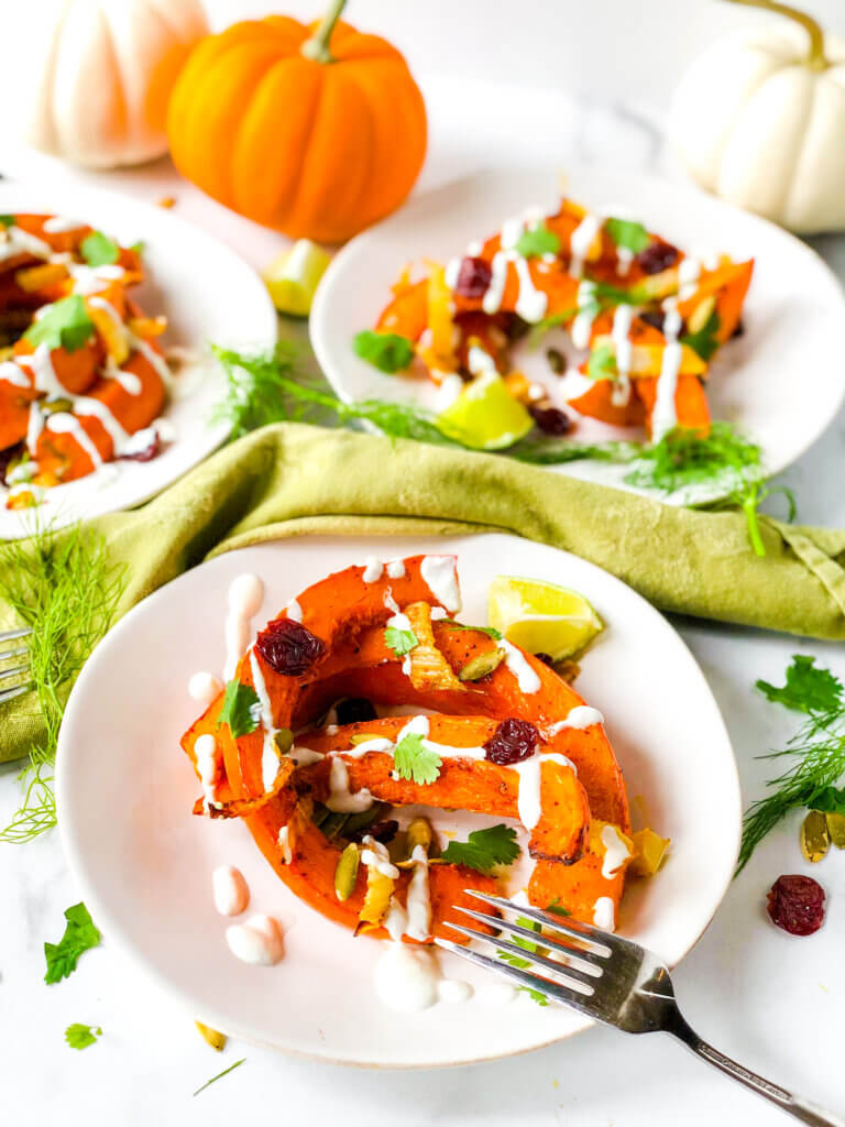 Blog photo Showing dressed salads of red kuri squash crescents, dried cherries, and pepitas, all topped with creamy dressing