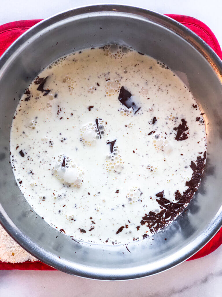 Process Shot Chocolate Peanut Pie Bars Recipe Ingredients showing warm cream melting the chopped chocolate