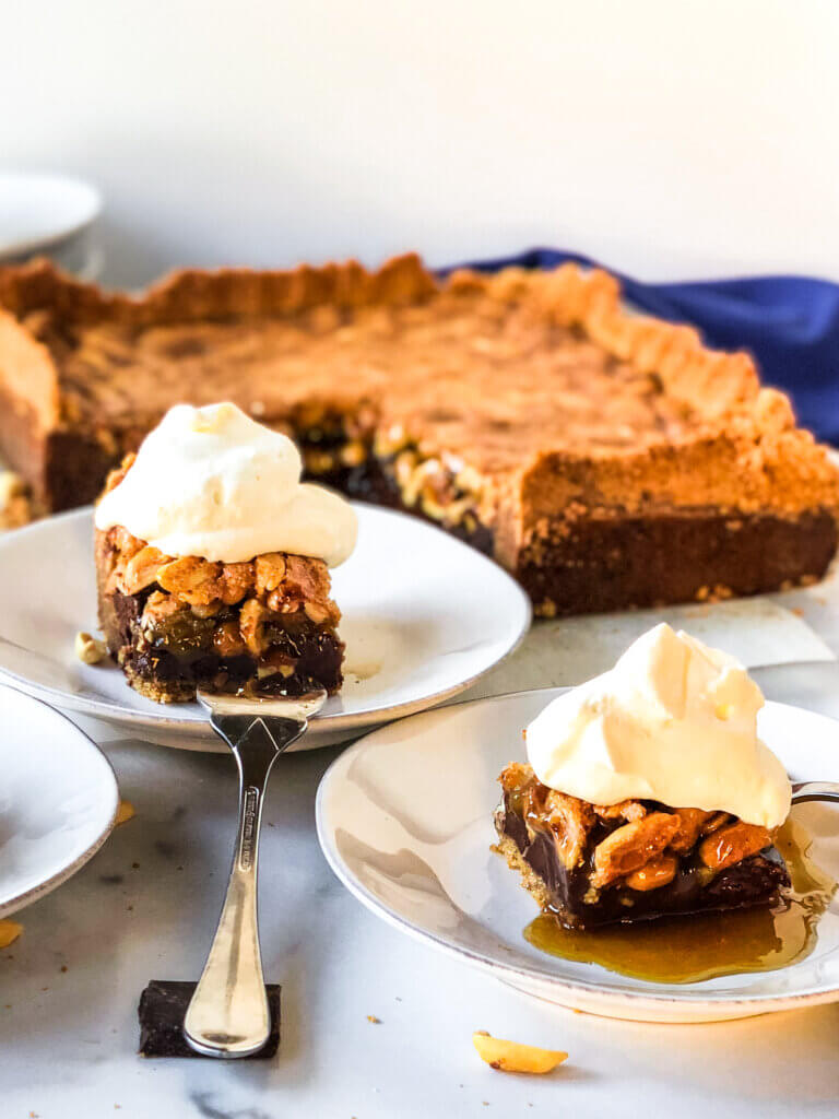 Blog photo showing chocolate peanut pie bars with whipped cream