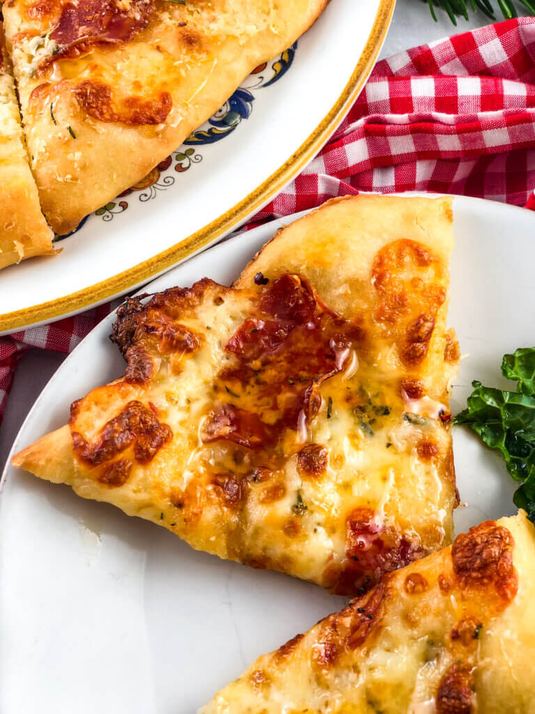 blog post photo: Closeup view of slices of pizza, drizzled with shimmering honey