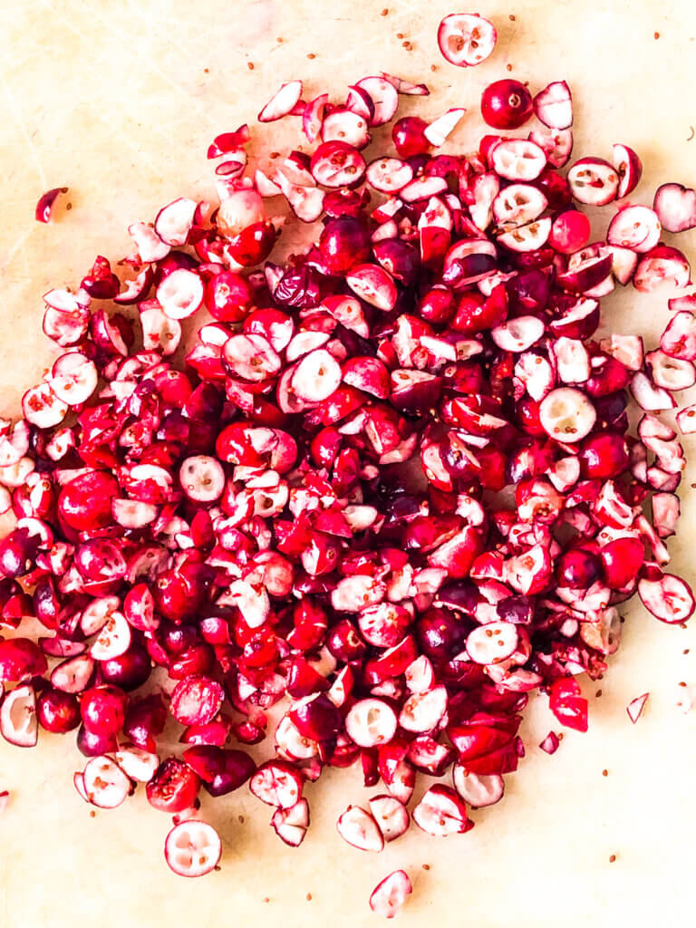 Process shot Shows chopped cranberries, each cranberry chopped into 2-3 pieces
