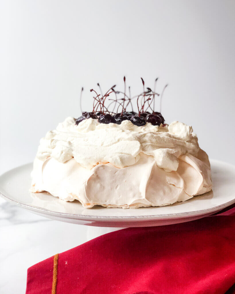 Pavlova with Mascarpone whipped cream and topped with amarena cherries