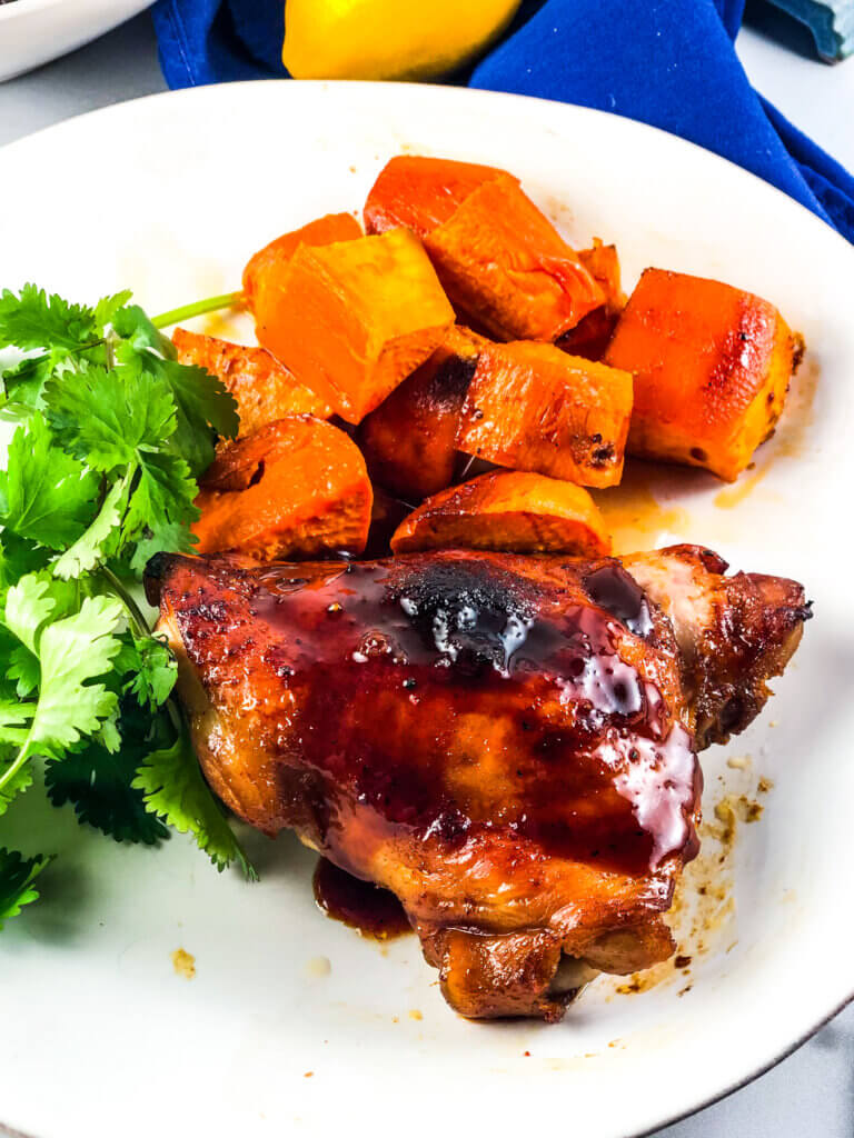 Blog photo showing overhead view of plate of roasted sheet pan maple chicken and sweet potatoes