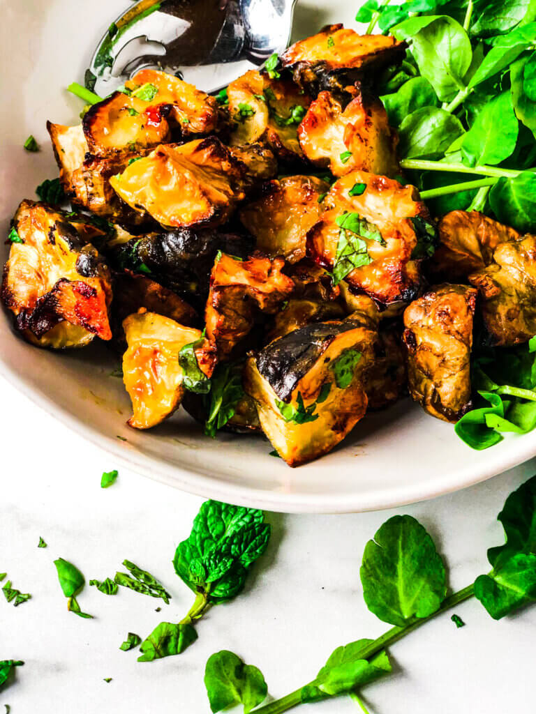 Crispy roasted Sunchokes on a bed of watercress and sprinkled with fresh basil and mint