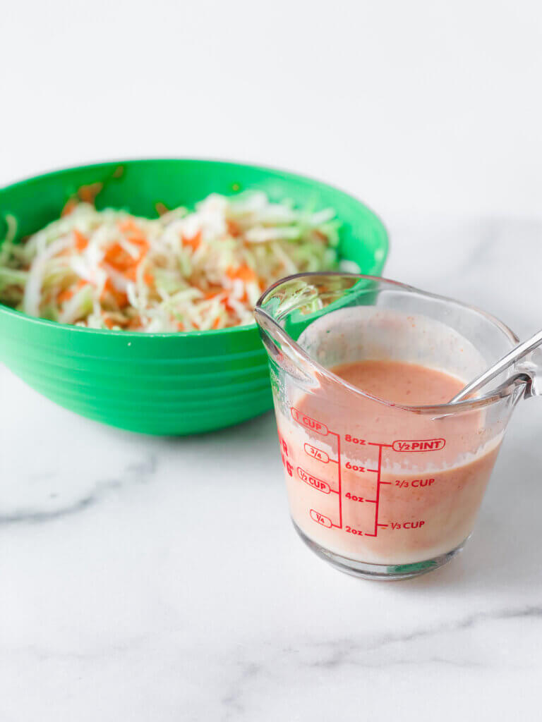 sweet and spicy dressing with bowl of slaw mix