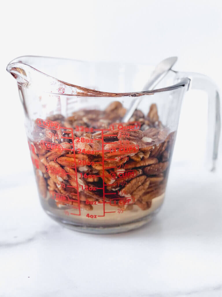 Soak nuts in sugar-water 10 minutes before coating and roasting