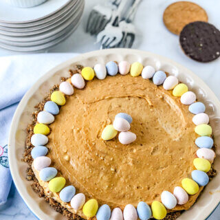 Salty Peanut Butter Caramel Cheesecake Pie, with mini chocolate eggs on top is so flavorful and perfect for a Spring Holiday and easy enough for any day!