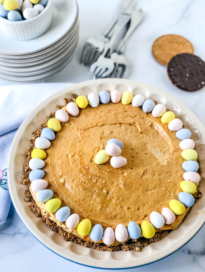 Salty Peanut Butter Caramel Cheesecake Pie, with mini chocolate eggs on top is so flavorful and perfect for a Spring Holiday and easy enough for any day!