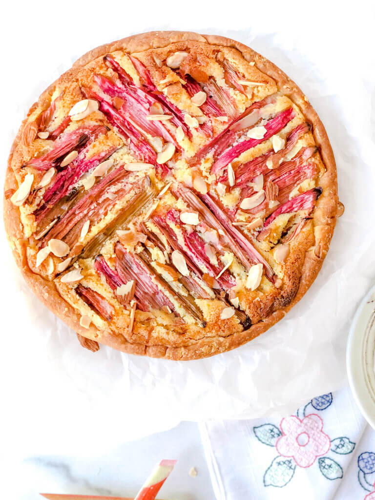 Rhubarb Frangipane Tart is a variation of the classic Bakewell tart. Adapted from a Mary Berry recipe this tart is filled with almond frangipane and topped with rhubarb and toasted almonds.