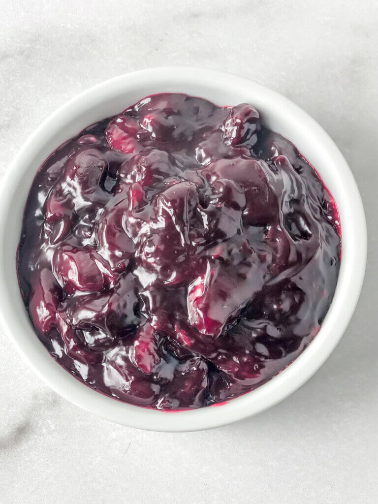 Thick, glossy Sweet Cherry Sauce in white bowl