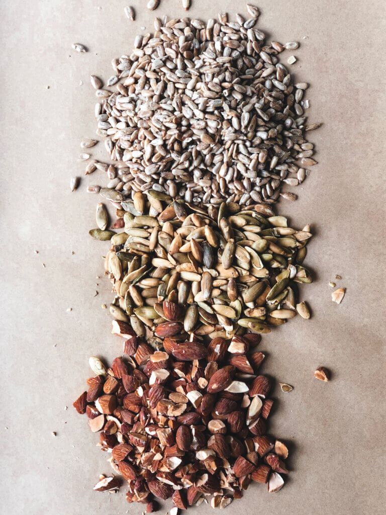 process shot showing roasted sesame seeds, pepitas, and almonds