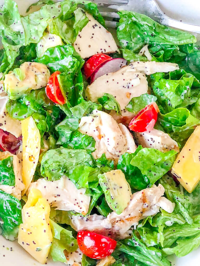 Lime Poppy Seed Dressing is tangy, sweet, creamy, the perfect compliment to salad of grilled chicken, avocado,  mangoes and greens