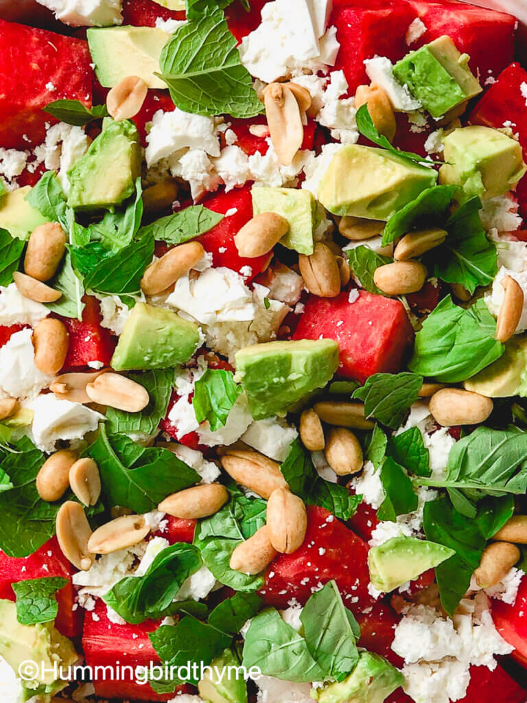 Flavor bomb of a salad! Watermelon Feta Salad with feta, avocado, roasted peanuts, topped with tangy lime dressing and fresh mint and basil