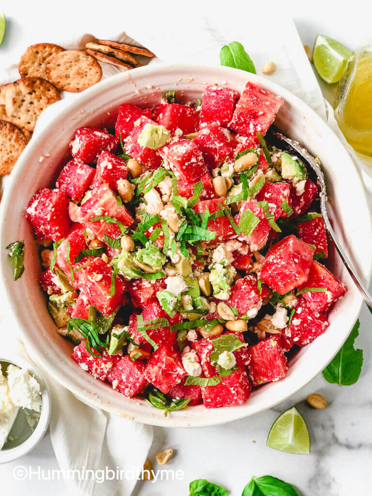 Flavor bomb of a salad! Watermelon Feta Salad with feta, avocado, roasted peanuts, topped with tangy lime dressing and fresh mint and basil