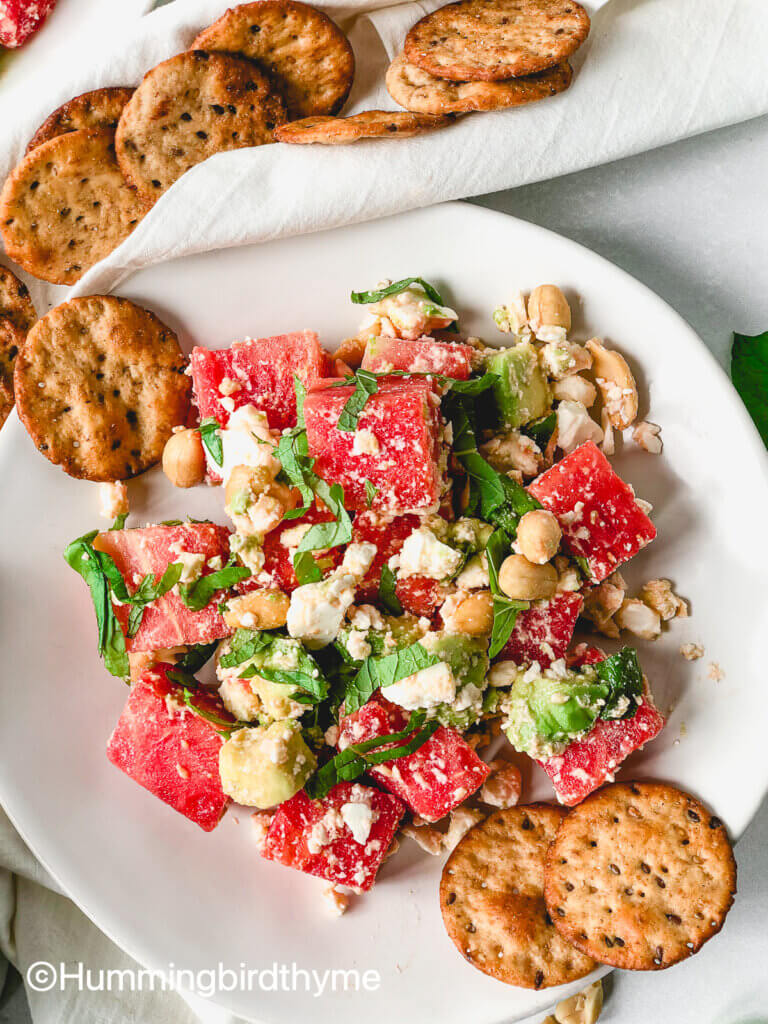 Flavor bomb of a salad! Watermelon Feta Salad with feta, avocado, roasted peanuts, topped with tangy lime dressing and fresh mint and basil